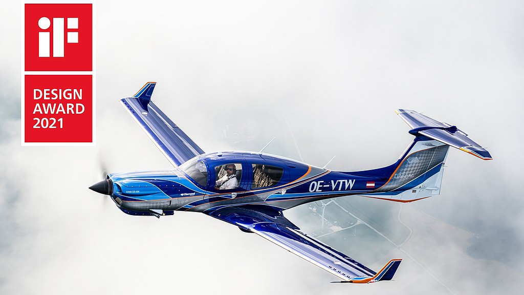 DA50 RG in blue and orange design soaring through clouds. 