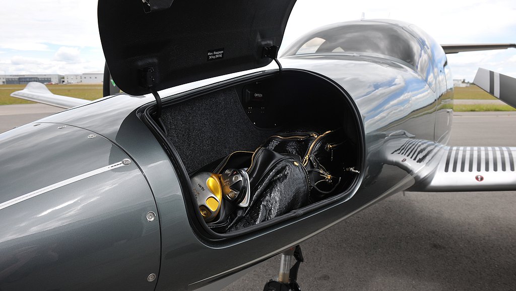 Open nose compartment of a DA62 with a golfbag inside.