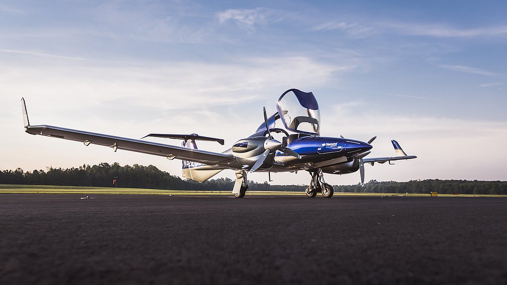 Blue DA42-VI with open doors standing on the ramp. 