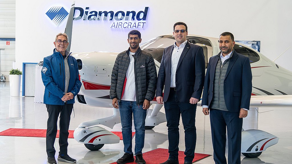 Sama Aviation and Diamond Aircraft team standing in front of a DA40 NG in the hanger.