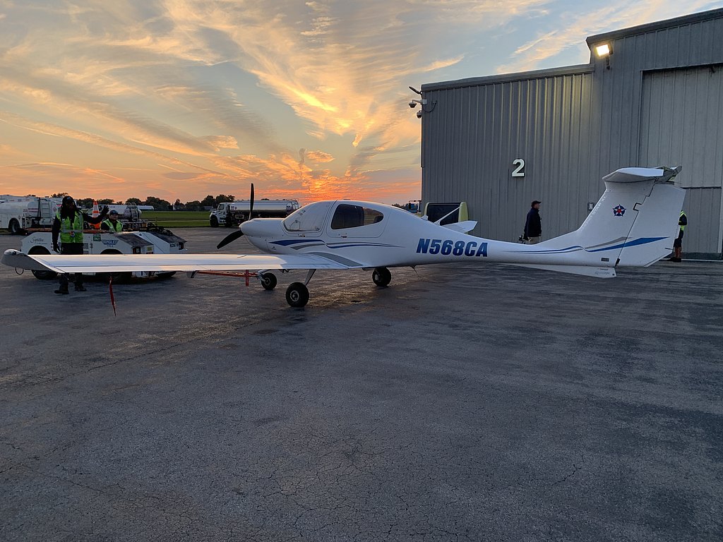 DA40 standing in front of a hanger at sunset.