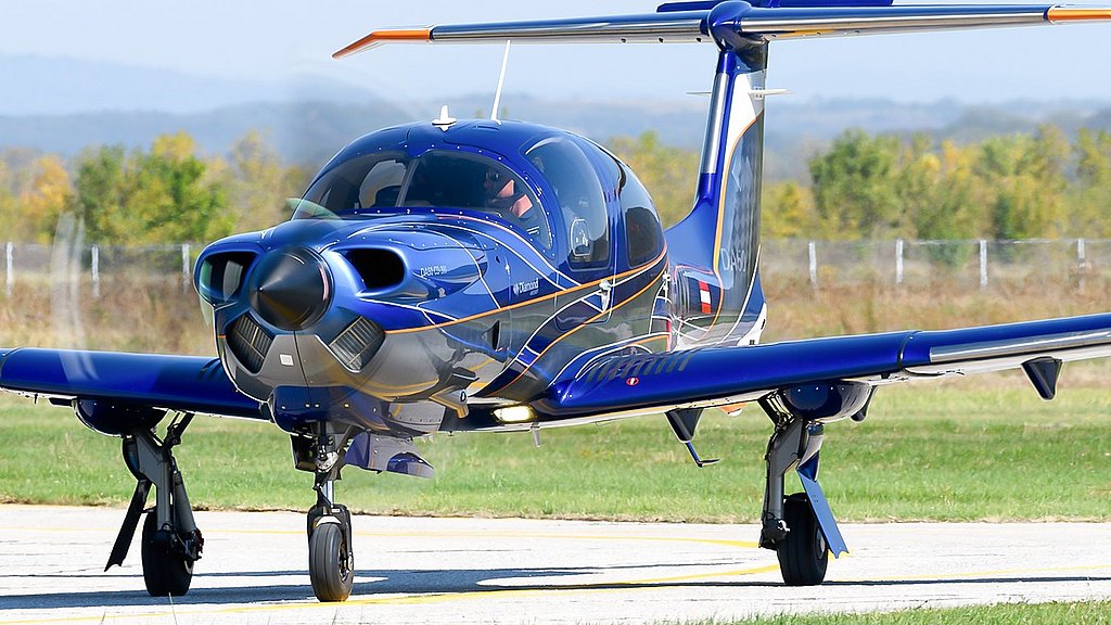 Blue DA50 RG taxiing on the apron.