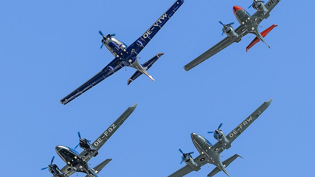 Four Diamond aicraft flying in diamond formation in blue skies.