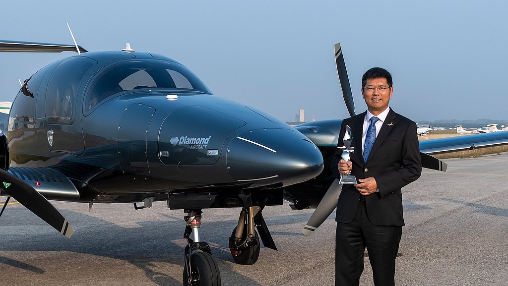 Chariman Bin Chen standing in front of a DA62 on the ramp. 