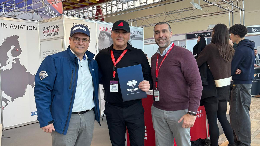 Three men stading at the Airways Aviation booth during the event.