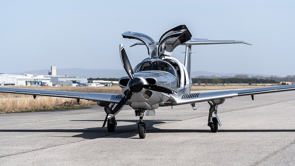 Silver DA50 RG with open gullwing doors standing on the ramp. 